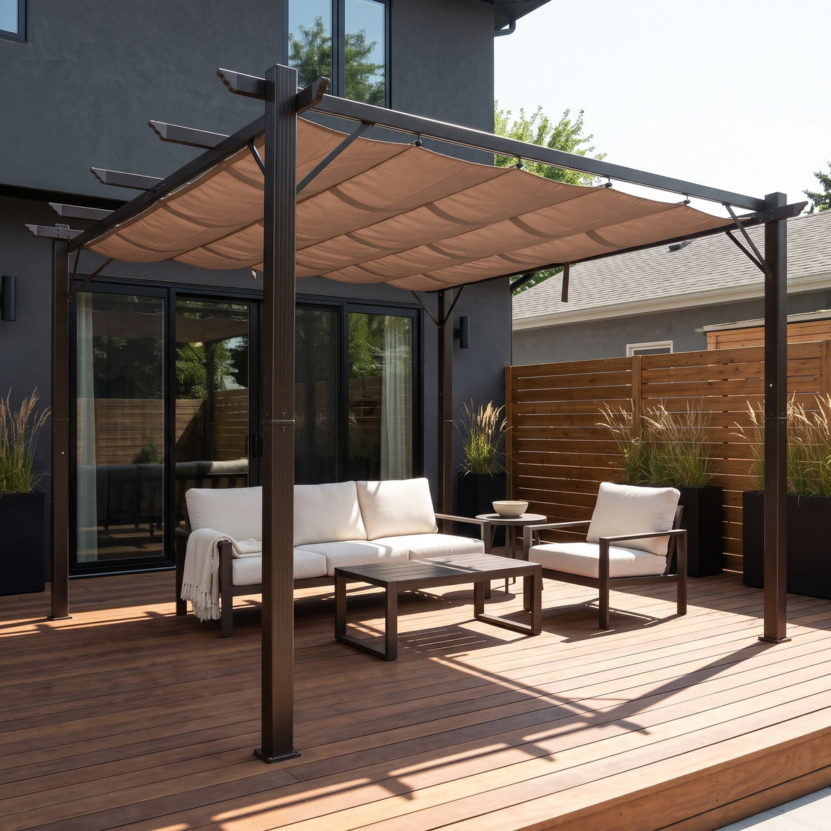 Brown aluminum 10x10 pergola with a taupe retractable canopy over cream patio seating on a wood deck