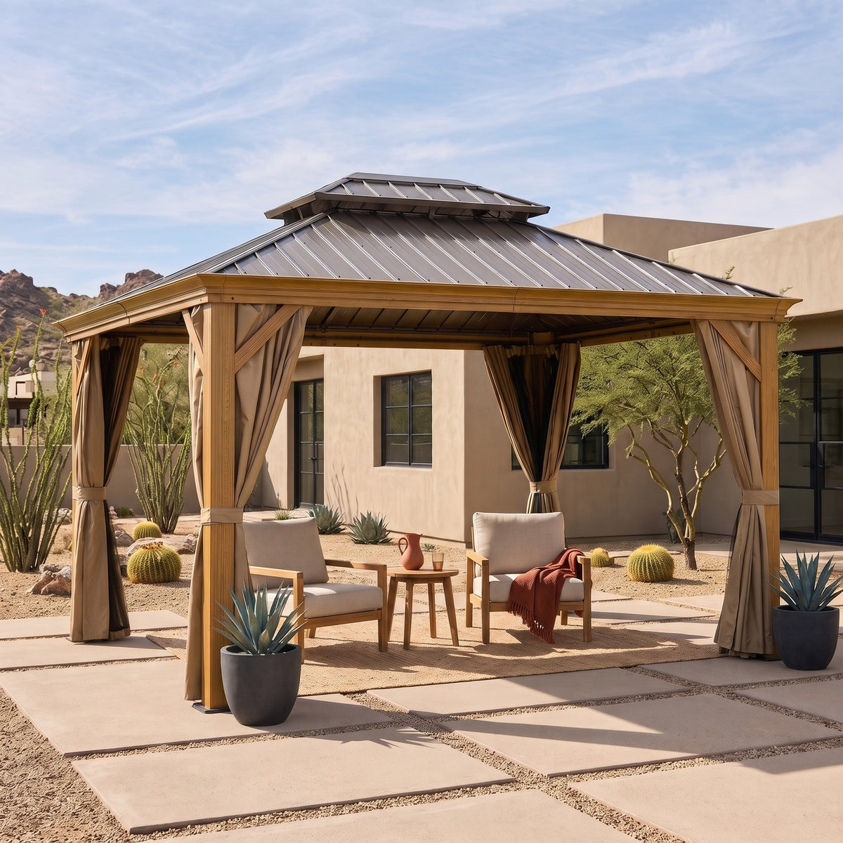 Wood grain aluminum 10x14 hardtop gazebo with tan curtains over two lounge chairs in a desert courtyard