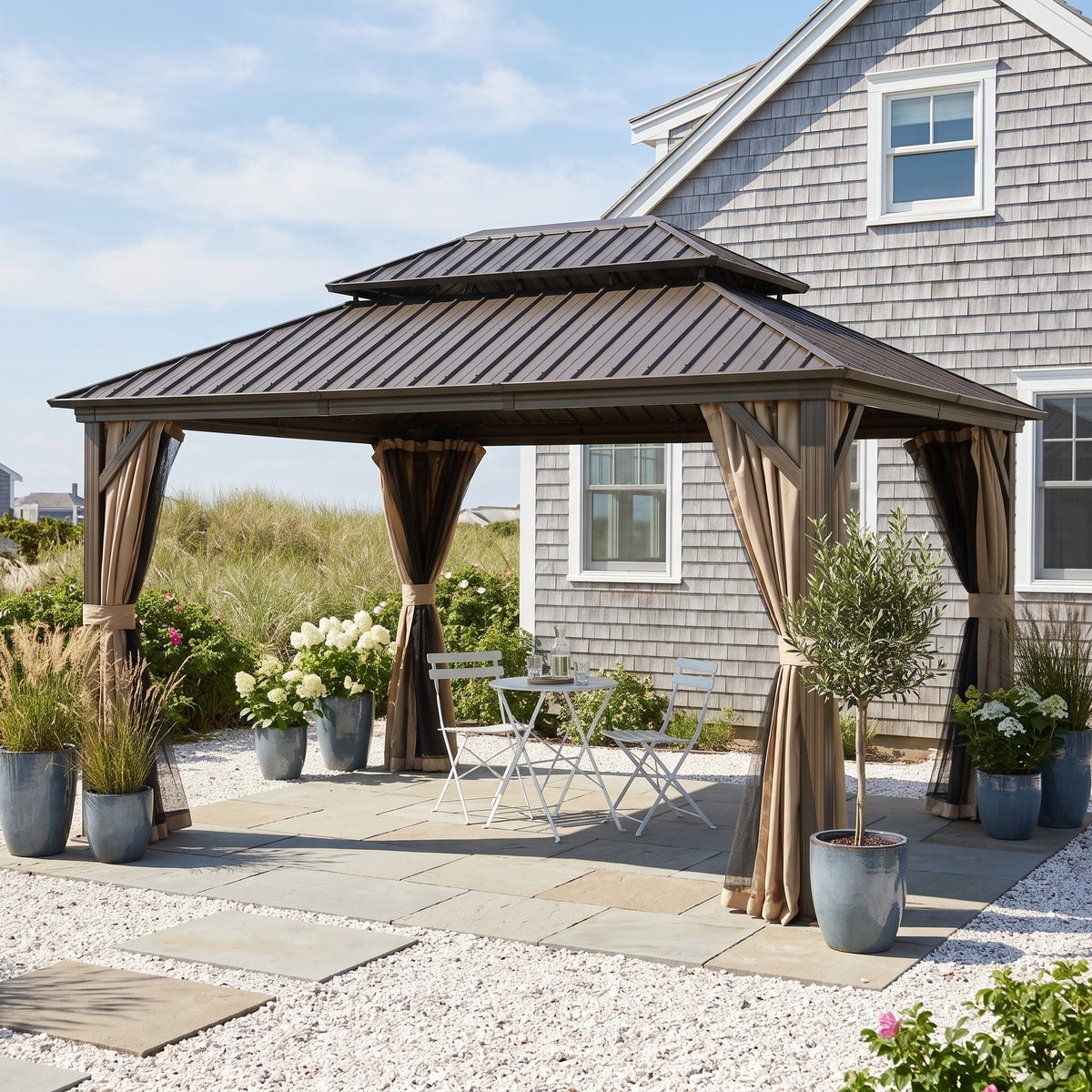 Brown aluminum 12x16 double roof hardtop gazebo with tied back curtains over a bistro set on a stone patio
