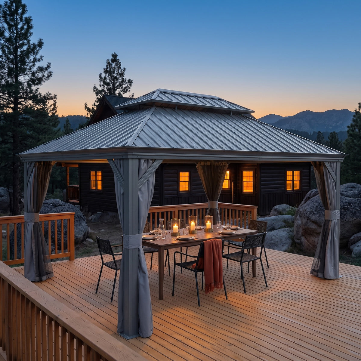 Gray aluminum 12x16 double roof hardtop gazebo over a candlelit dining table on a wood deck at dusk