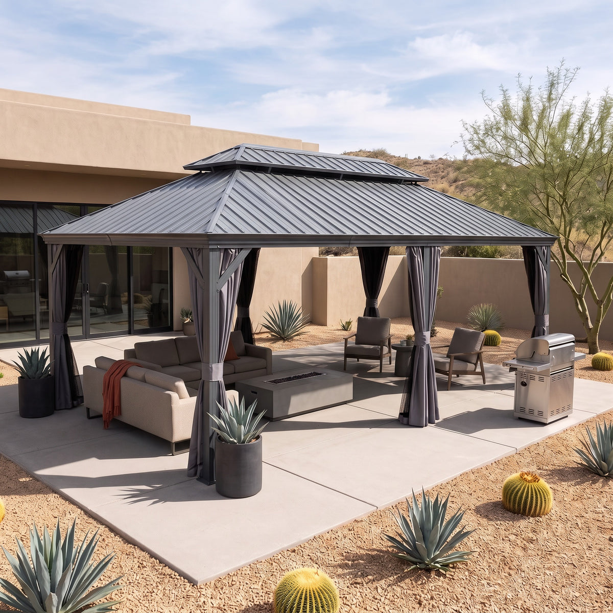 Gray steel 12x24 double roof hardtop gazebo with curtains tied back over a lounge and fire table on a desert patio