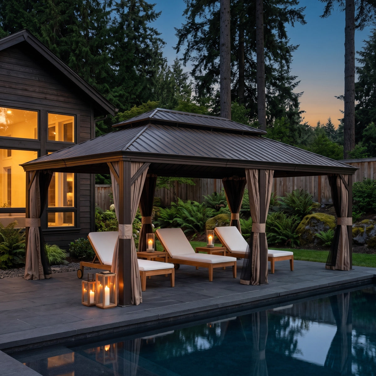 Brown aluminum double roof hardtop gazebo with tan curtains over teak loungers beside a pool at dusk