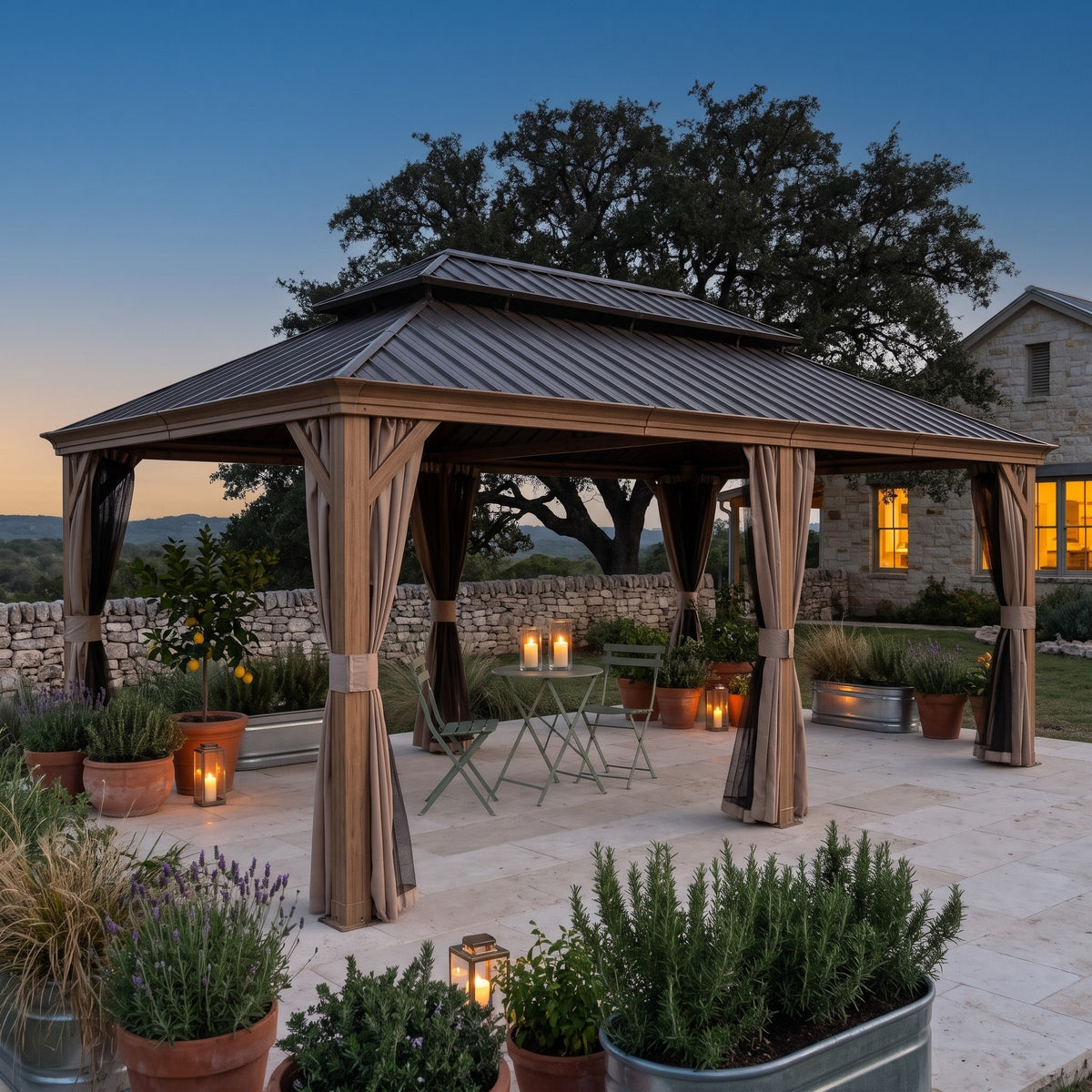 Yellow brown aluminum 14x24 double roof hardtop gazebo with tied back curtains over a bistro set on a stone patio at dusk