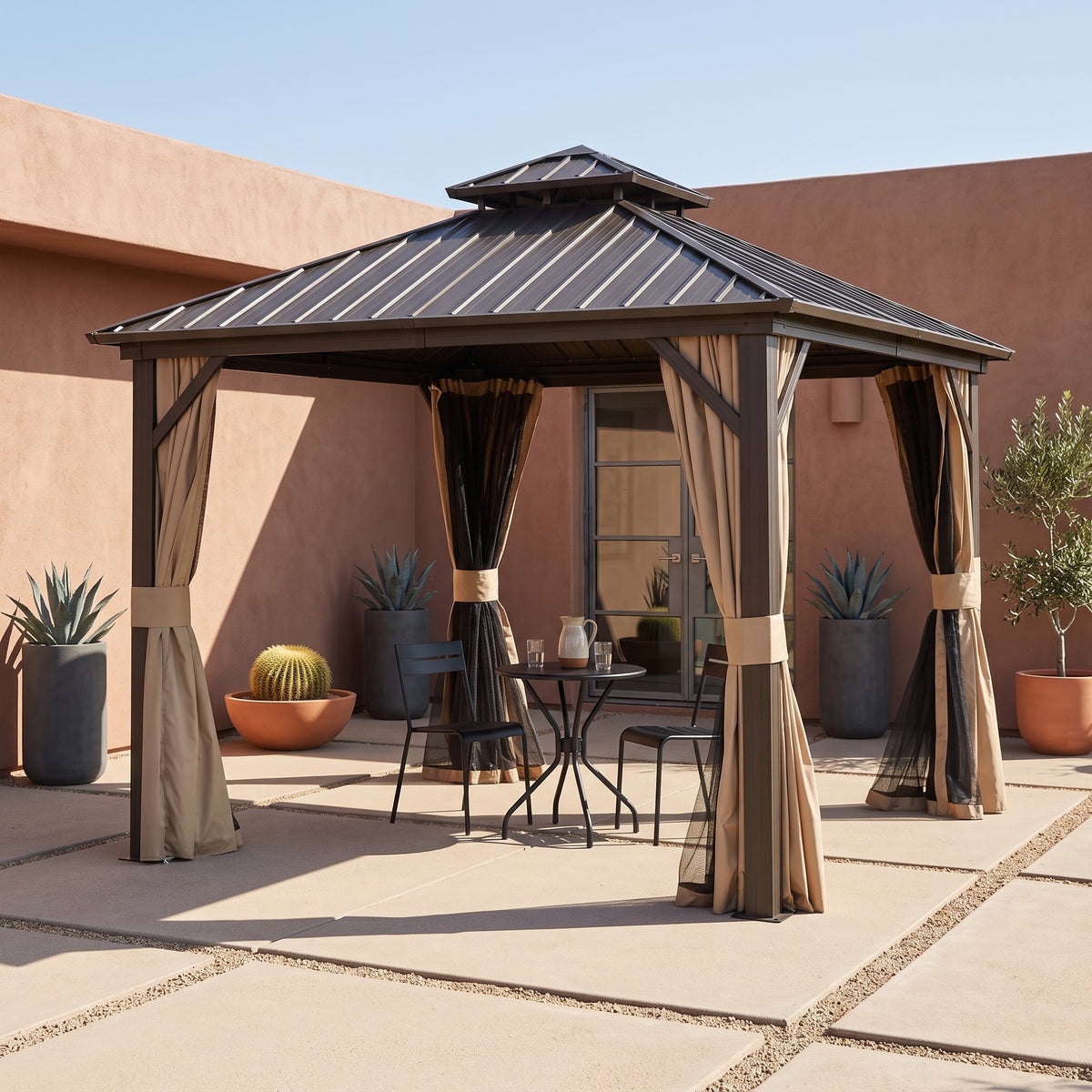 Brown aluminum 8x8 double roof hardtop gazebo with tied beige curtains over a bistro table in a sunny desert courtyard