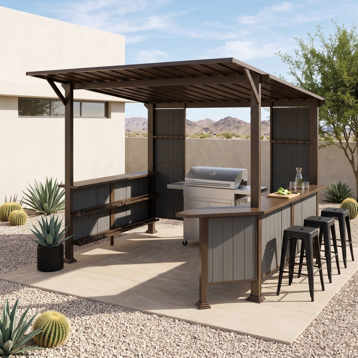 Brown steel slanted hardtop grill gazebo with bar counter, side shelves and stools on a desert patio in daylight