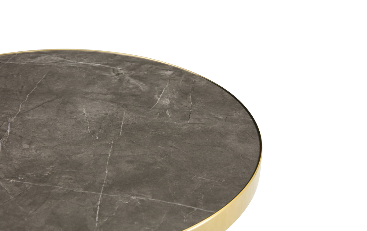 Close-up of the gray faux marble surface and gold rim of the bistro tabletop