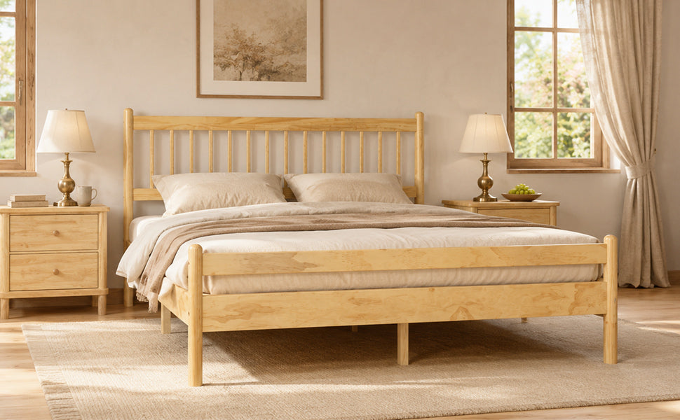 Angled view of the natural pine bed with spindle headboard and footboard and cream bedding
