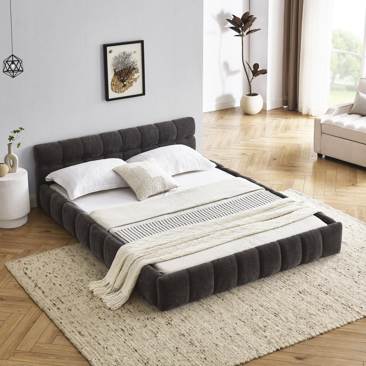 Dark grey chenille channel-tufted platform bed frame, angled view on white, wood slats exposed