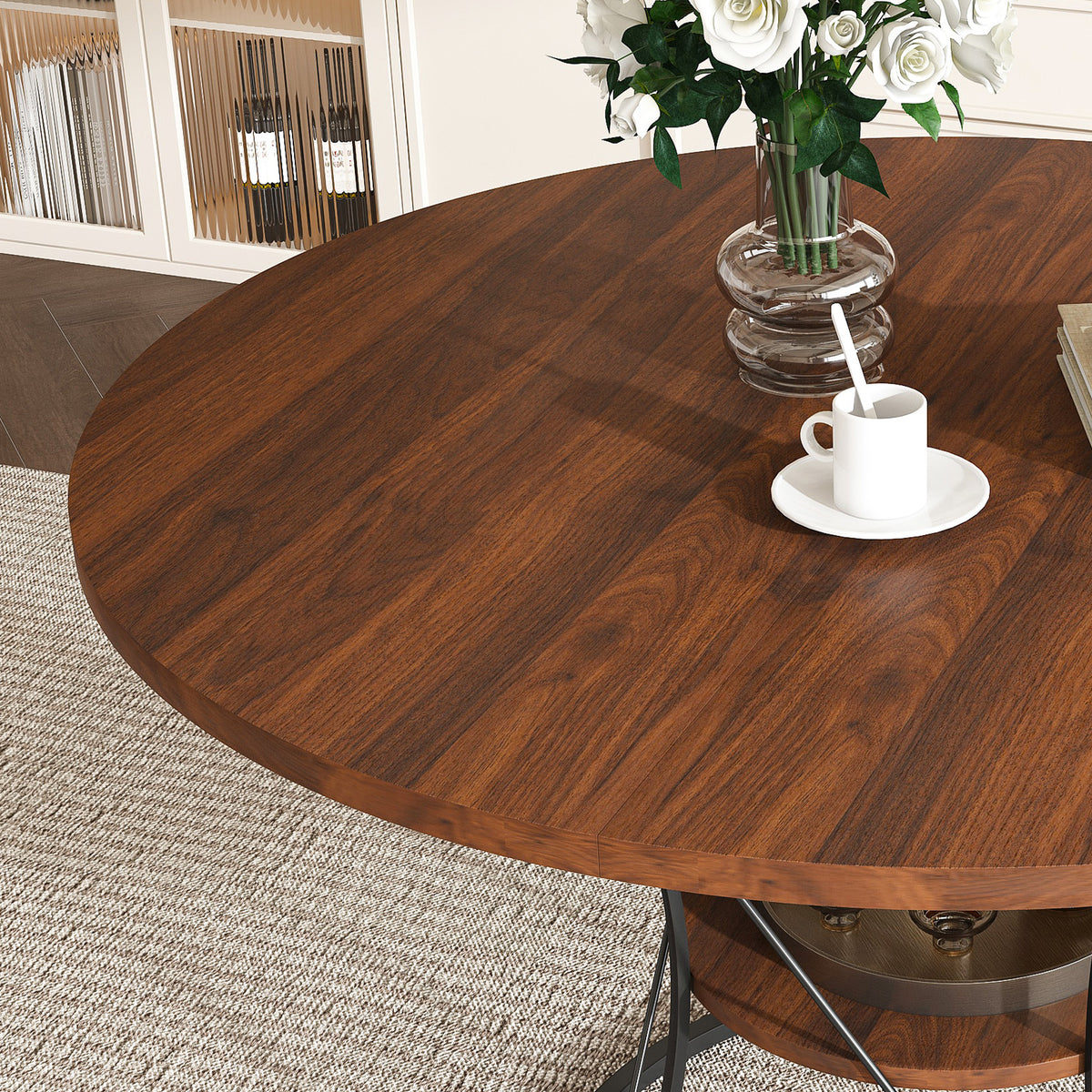 Walnut extendable round dining table with black iron cage base on a plain white background, three-quarter view
