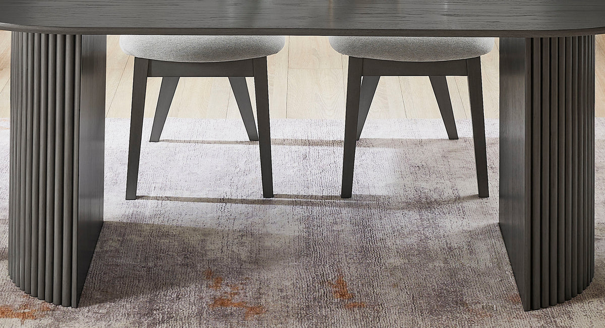 Under-table view of the gray oak oval dining table's dual pedestal bases with two chairs