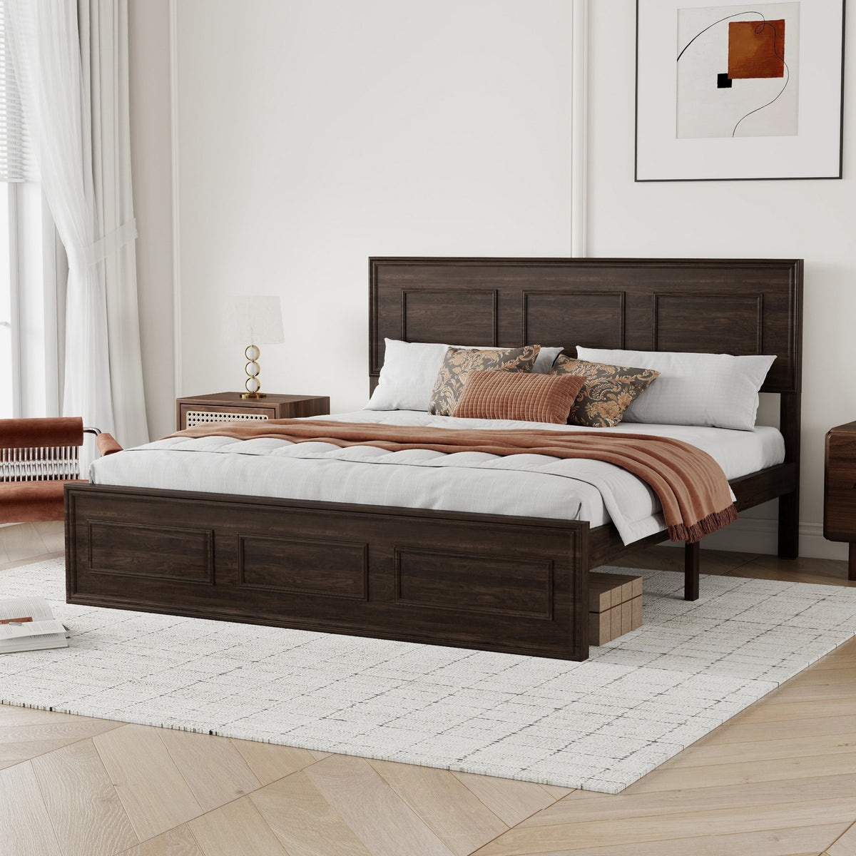 Angled view of rich brown queen panel bed with rust throw, nightstands and accent chair