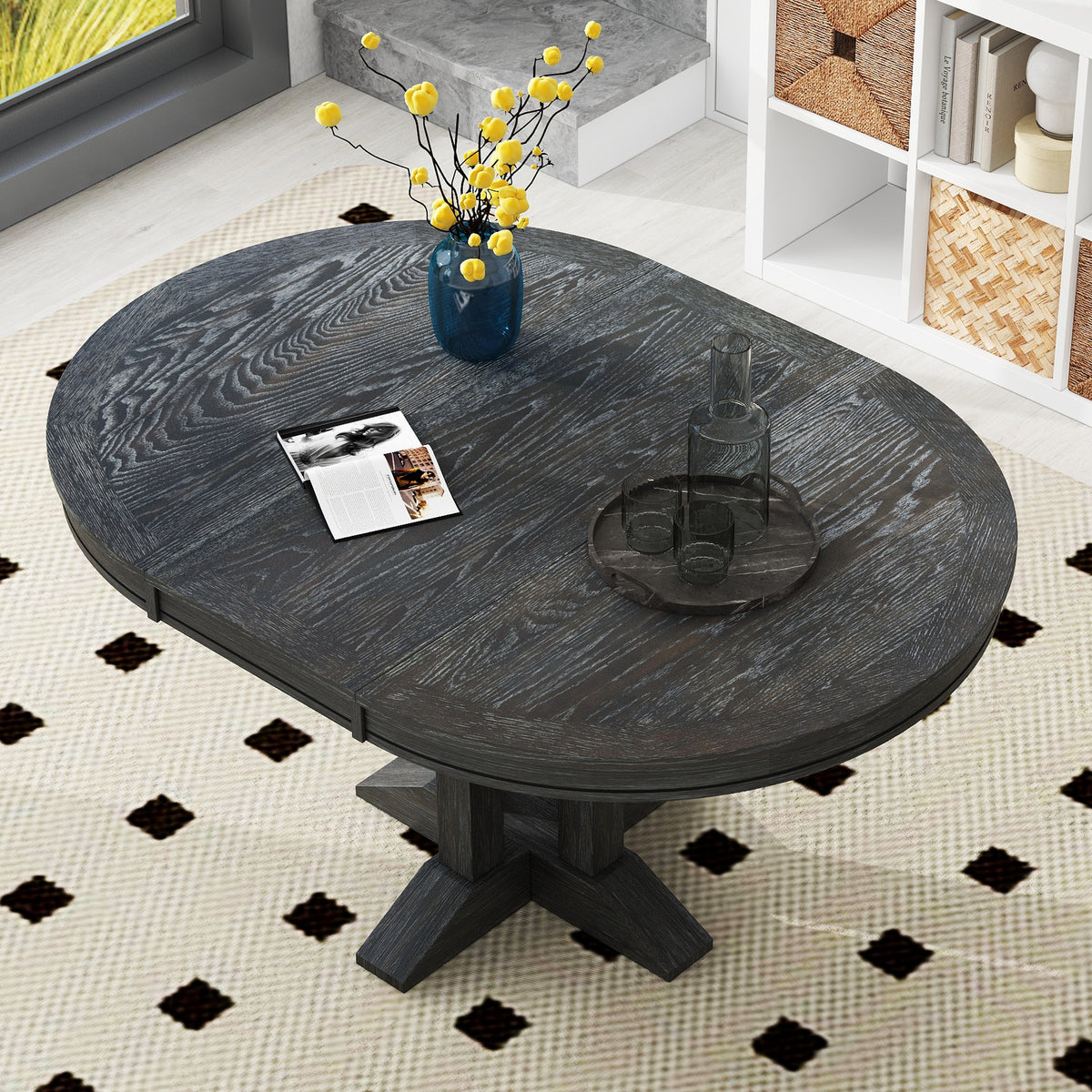 Overhead angled view of the black oval-extended tabletop in a styled room