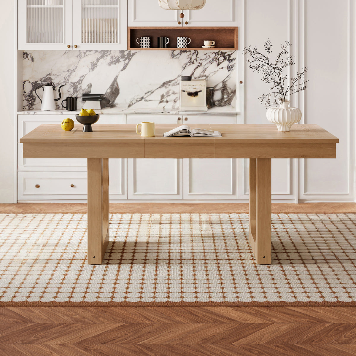 Front view of the natural oak extendable dining table in a styled kitchen with marble backsplash
