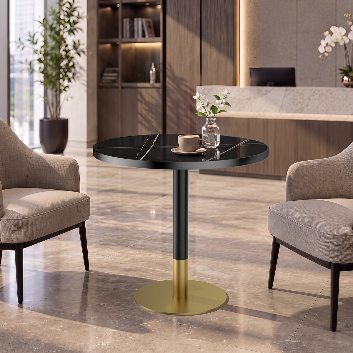 Styled lobby setting with the gold and black round dining table holding a coffee cup and flowers
