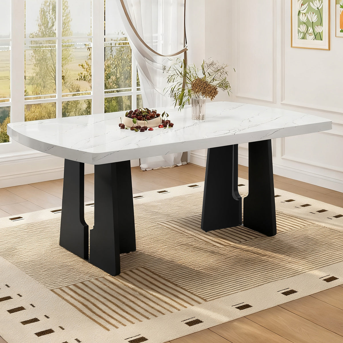 Faux marble dining table with black geometric legs styled in a bright room with cherries and flowers