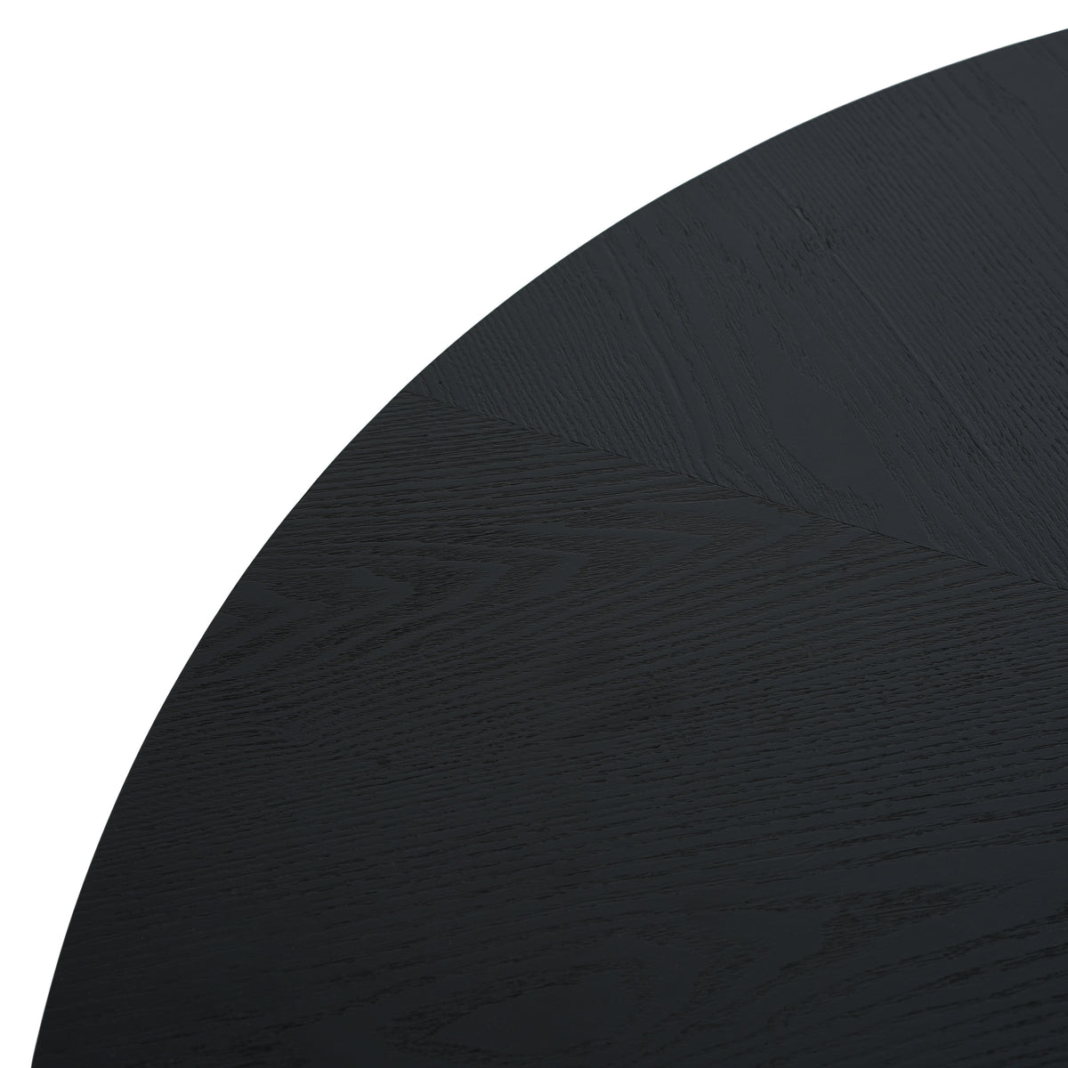 Overhead close-up of the black round tabletop edge and grain