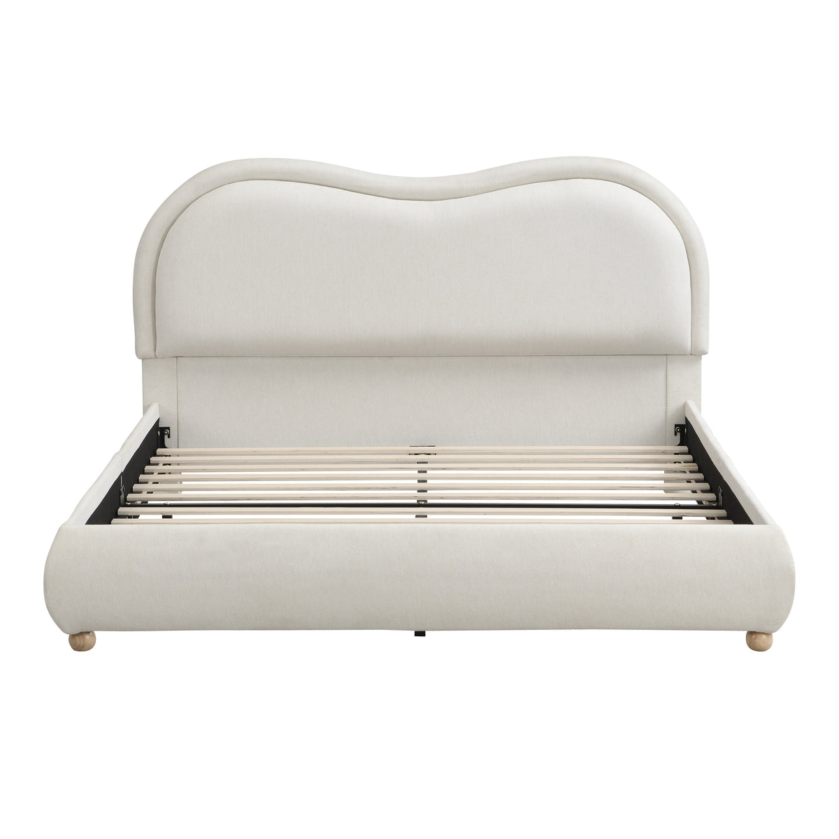 Angled view of beige chenille queen platform bed styled with white bedding in a bright bedroom