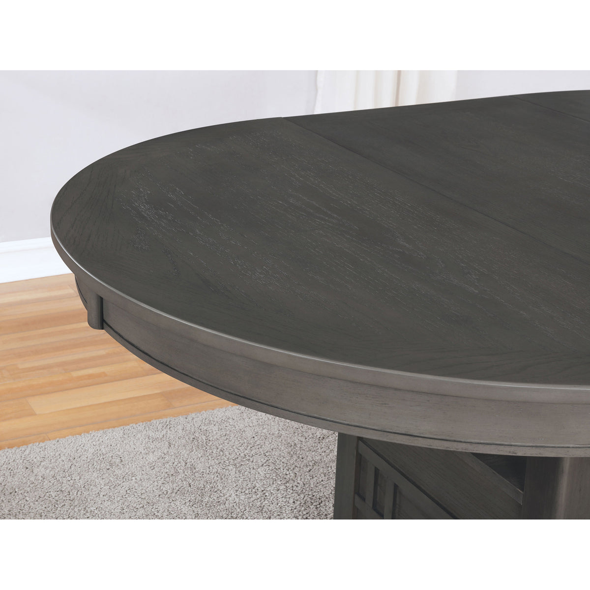 Close-up of the grey oval tabletop edge in a room setting