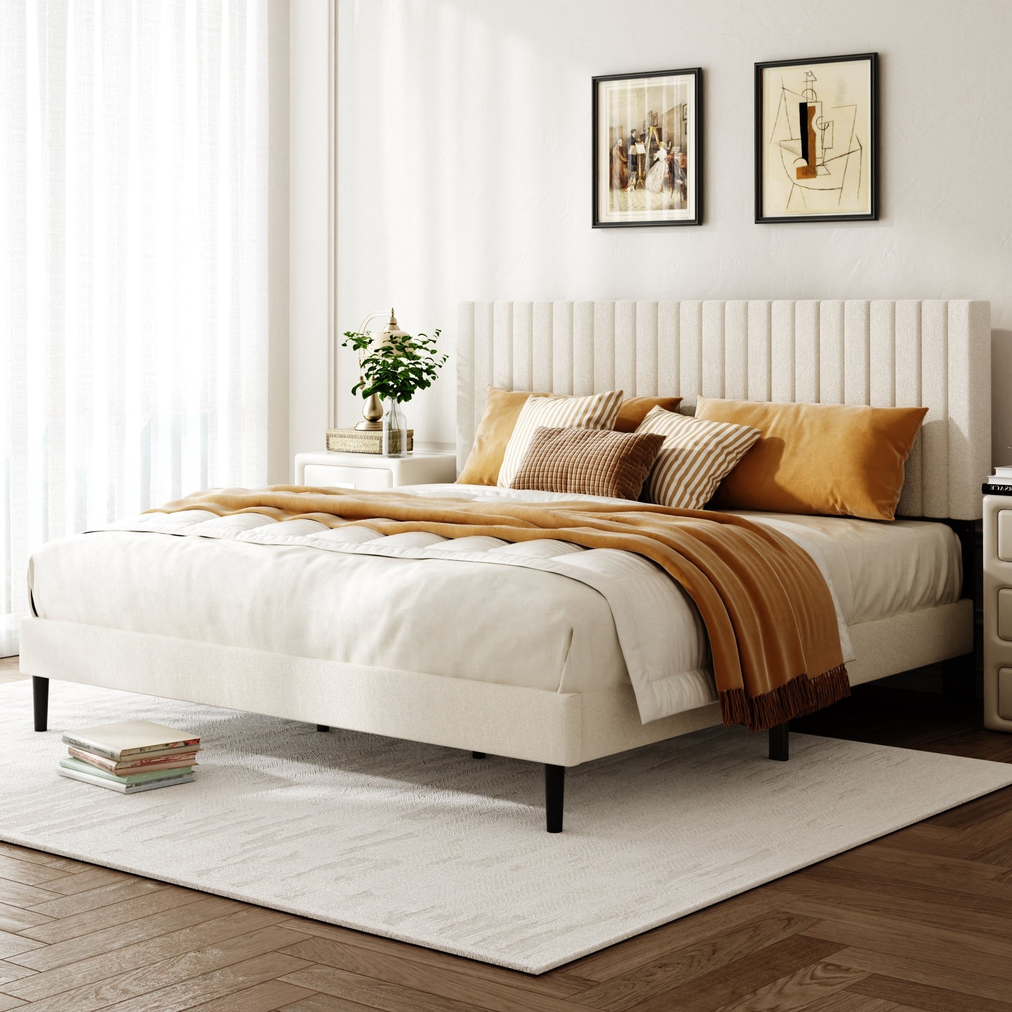 Beige velvet king platform bed frame in a bright bedroom with mustard throw pillows