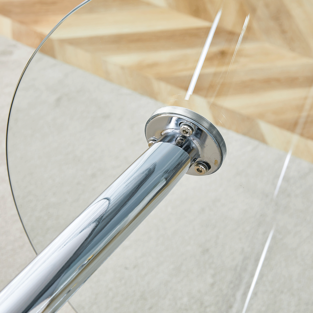 Overhead close-up of a silver suction-cup leg mount fastened under the glass tabletop