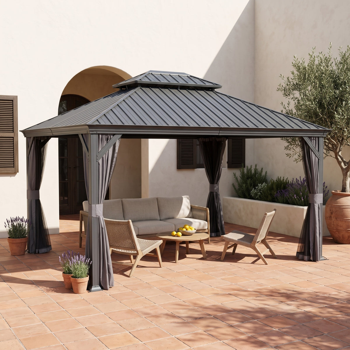 Gray metal 10x13 double roof hardtop gazebo with curtains over a sofa and lounge chairs on a terracotta patio