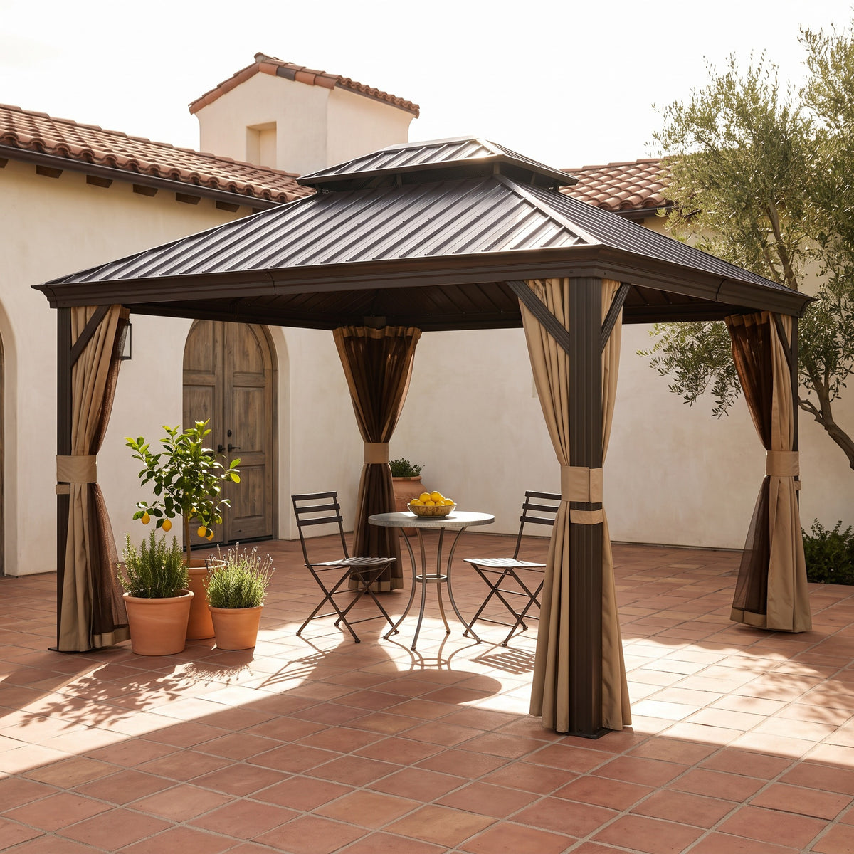 Brown aluminum double roof hardtop gazebo with tan curtains over a bistro table on a terracotta courtyard