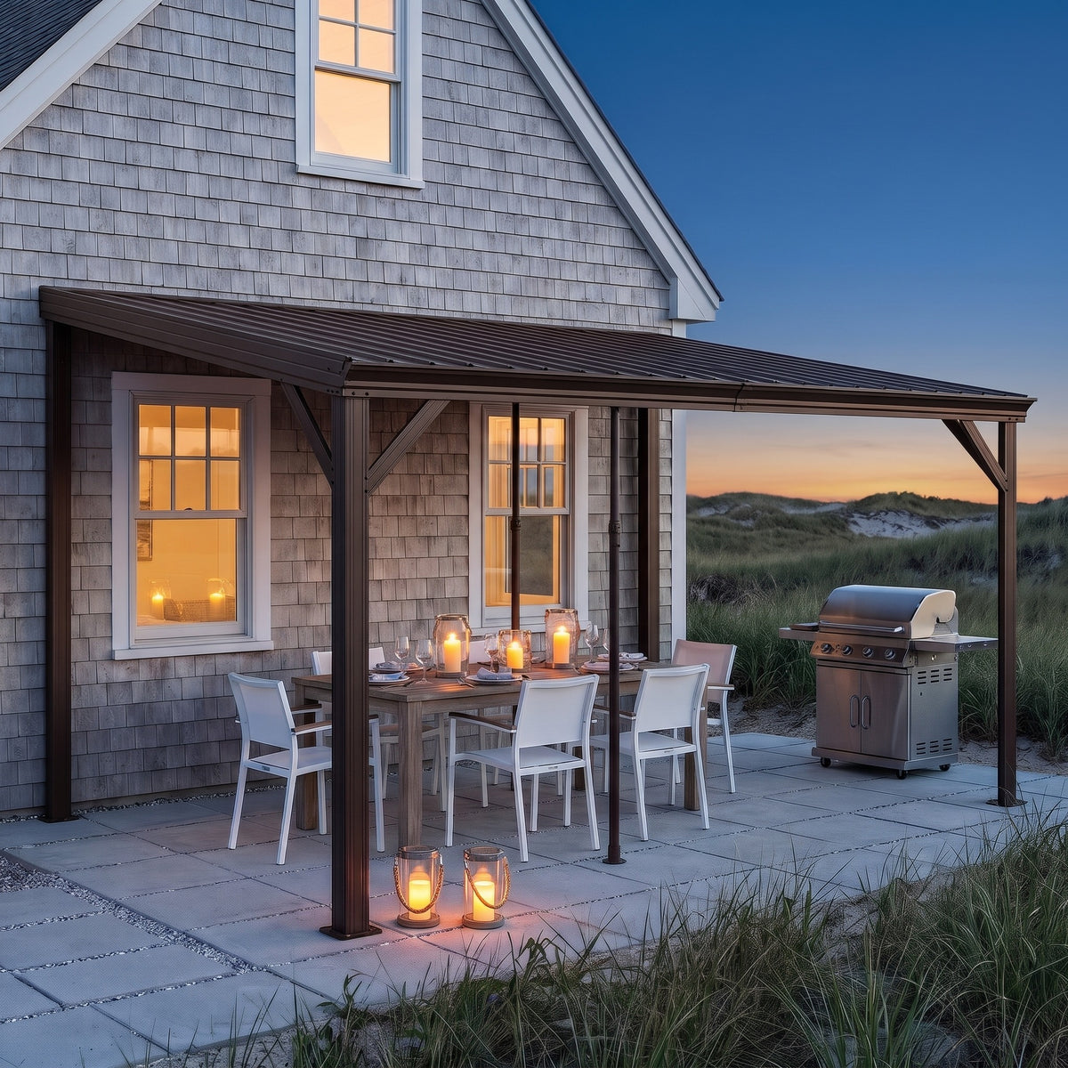 Brown metal lean-to hardtop gazebo on a shingled house over a dining table with candle lanterns at dusk