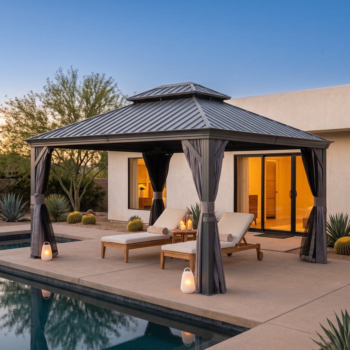 Gray aluminum 10x14 double roof hardtop gazebo over two lounge chairs by a pool at dusk