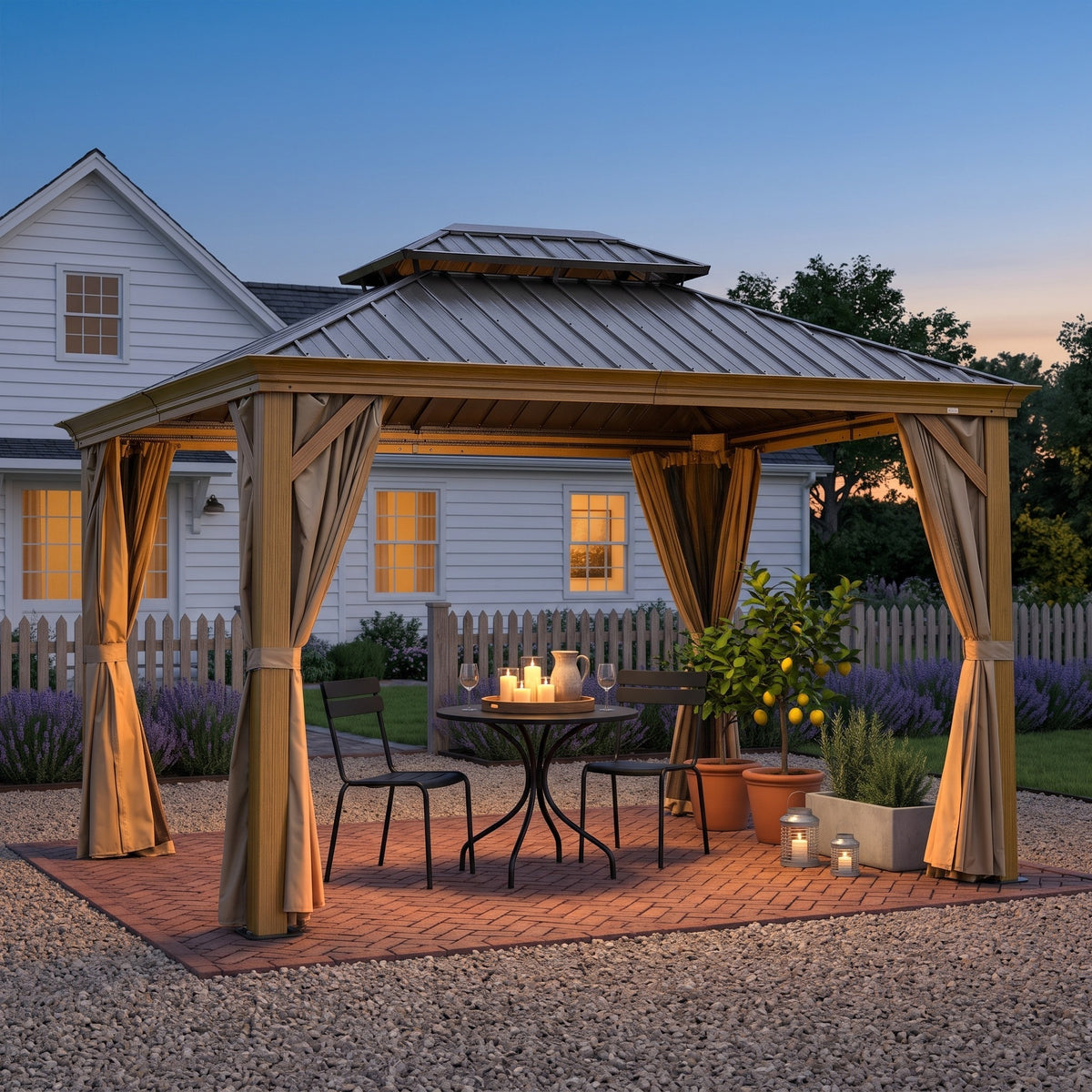 Wood grain aluminum double roof hardtop gazebo with tan curtains over a bistro table on a brick patio at dusk