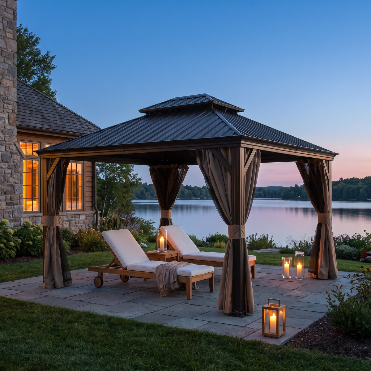 Brown aluminum double roof hardtop gazebo with tied back curtains over two lounge chairs on a lakeside patio at dusk