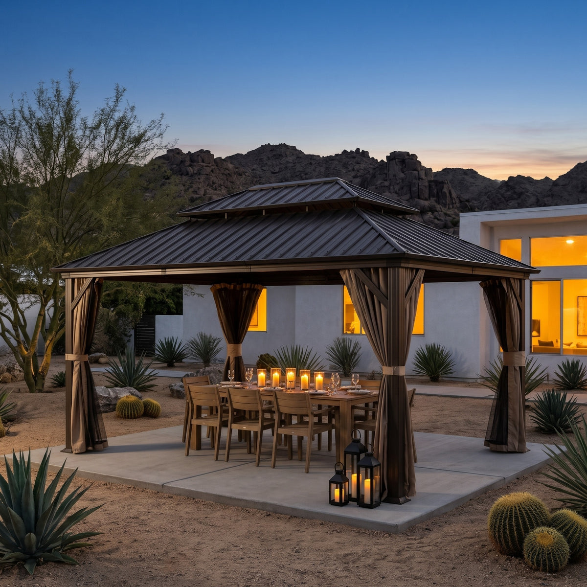 Brown aluminum 12x14 double roof gazebo with tied back curtains over a candlelit dining table in a desert yard at dusk