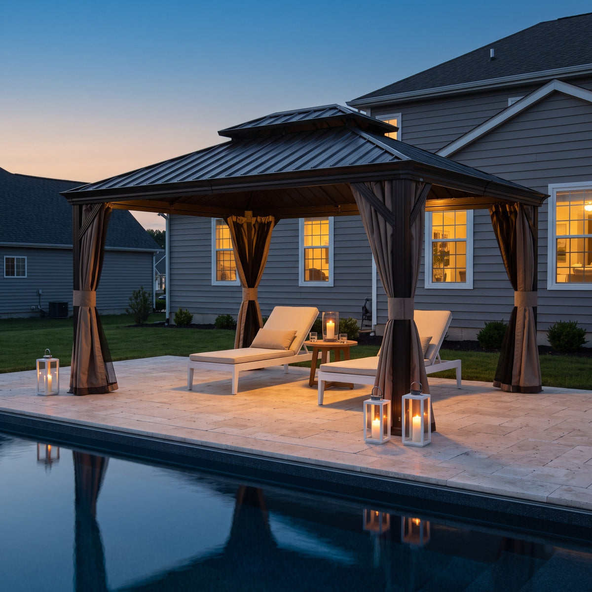 Brown 12x14 hardtop gazebo with tied back curtains over two loungers by a pool, lit by candle lanterns at dusk