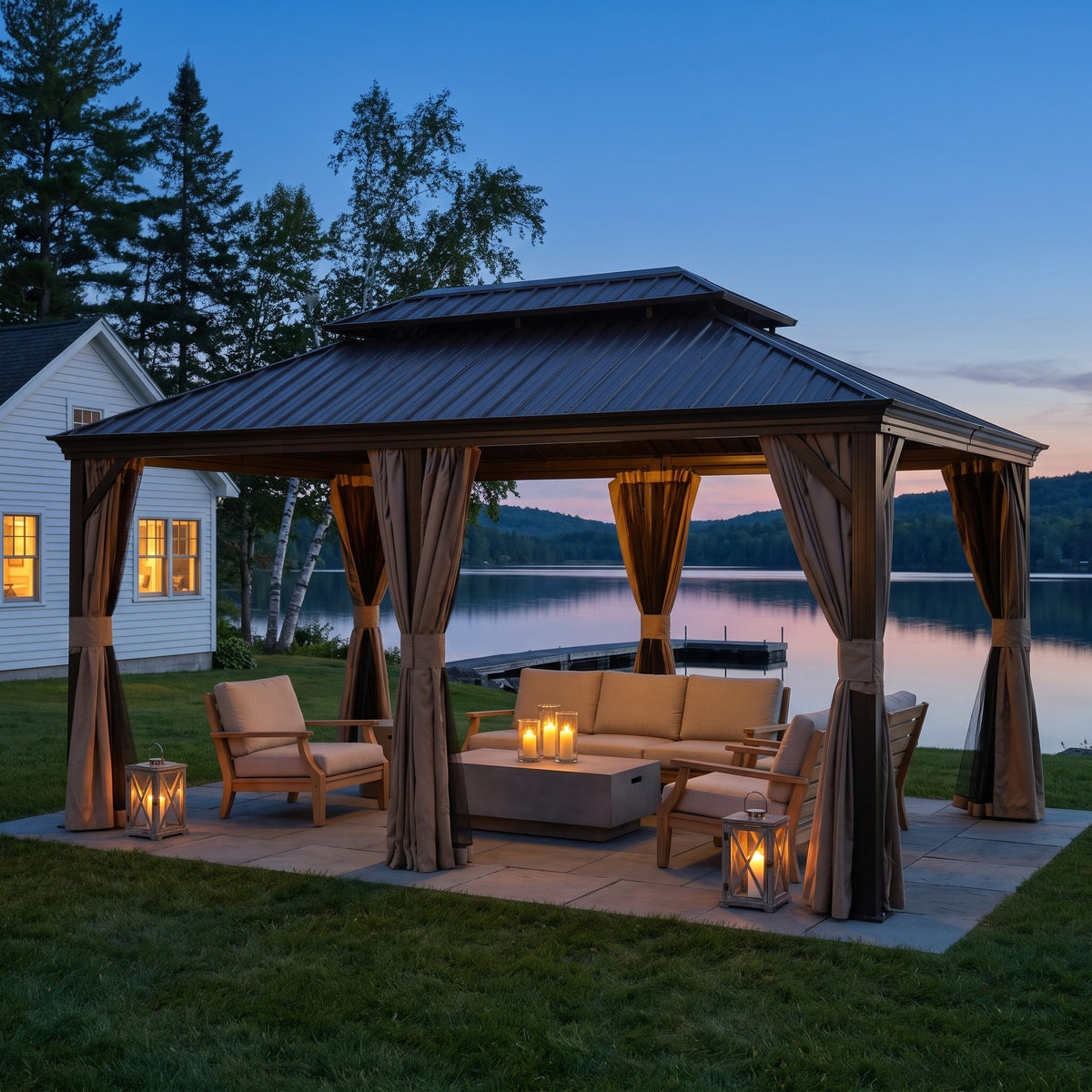 Brown aluminum 12x18 double roof gazebo with tan curtains and netting over lounge seating by a lake at dusk