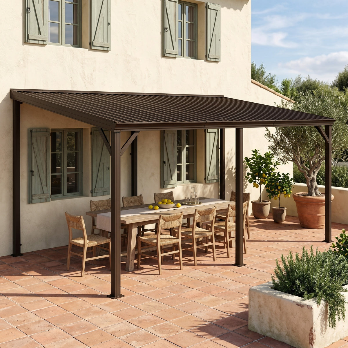 Brown metal 12x20 lean-to hardtop gazebo against a cream house wall over a wood dining table on a terracotta patio