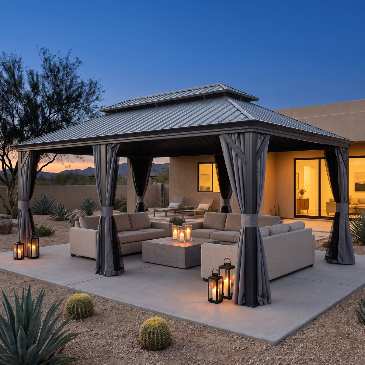 Gray steel 12x24 double roof hardtop gazebo with curtains over a lounge set on a desert patio at dusk
