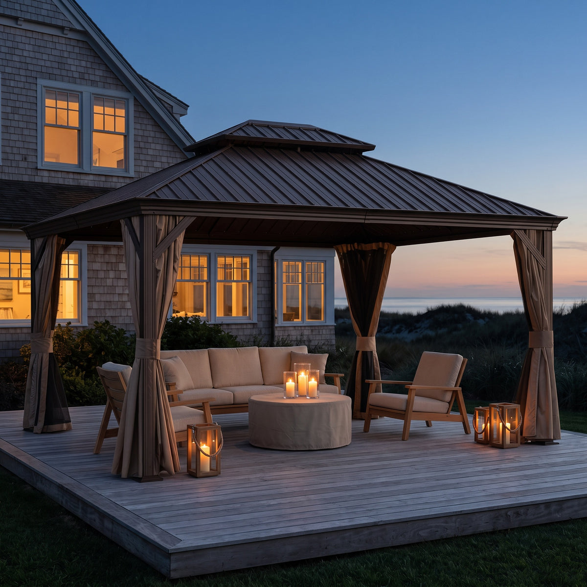 Brown steel double roof hardtop gazebo with tan curtains over a deck lounge set lit by candle lanterns at dusk