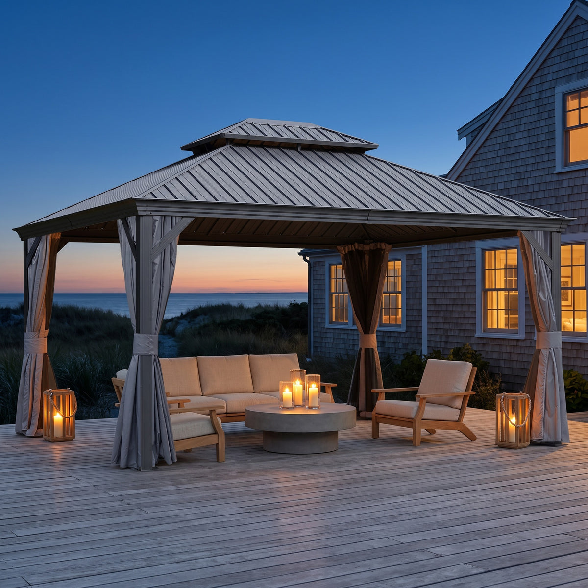 Gray steel double roof hardtop gazebo with curtains over a lounge set on a beach house deck at dusk
