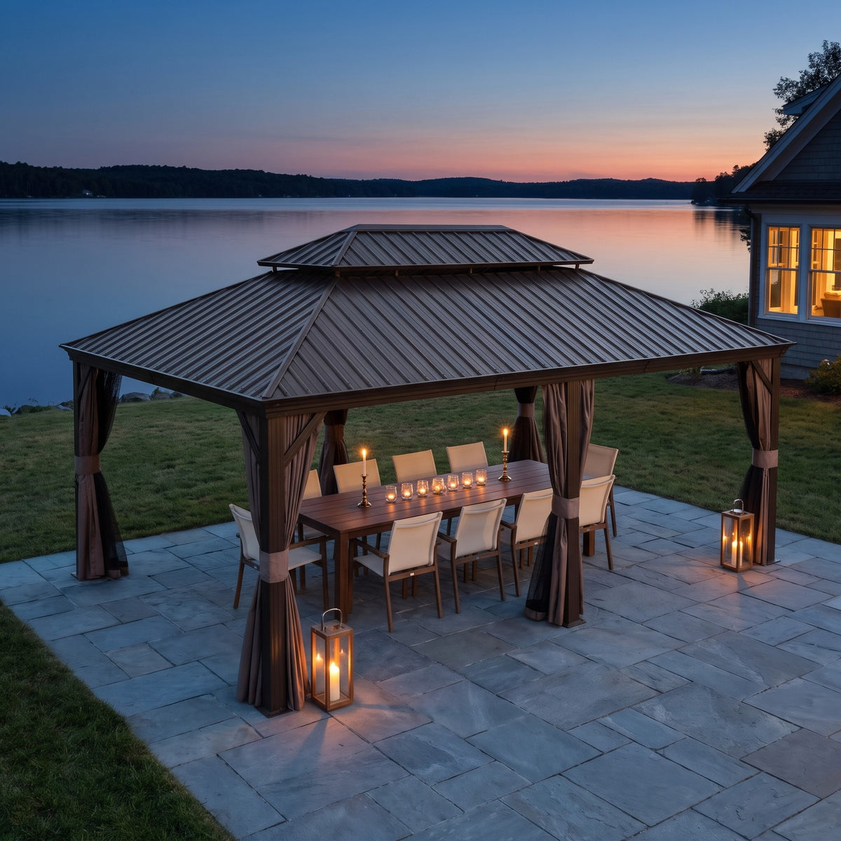Brown aluminum 14x20 double roof hardtop gazebo over a dining table on a stone patio by a lake at dusk