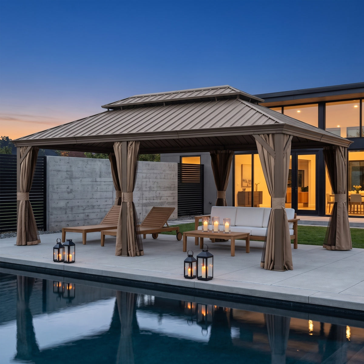 Brown 14x24 hardtop gazebo with tied-back curtains over loungers and a sofa beside a pool at dusk