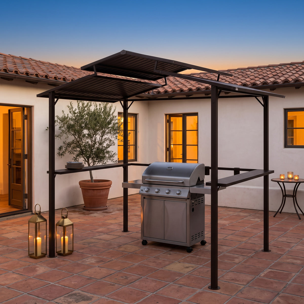 Dark brown metal grill gazebo with a two-tier roof over a steel grill on a terracotta patio at dusk