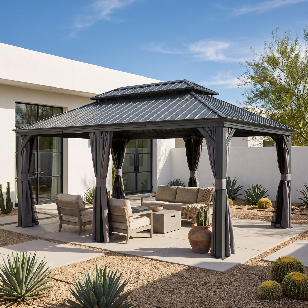 Gray aluminum double roof hardtop gazebo with curtains tied back over a lounge set on a desert courtyard patio