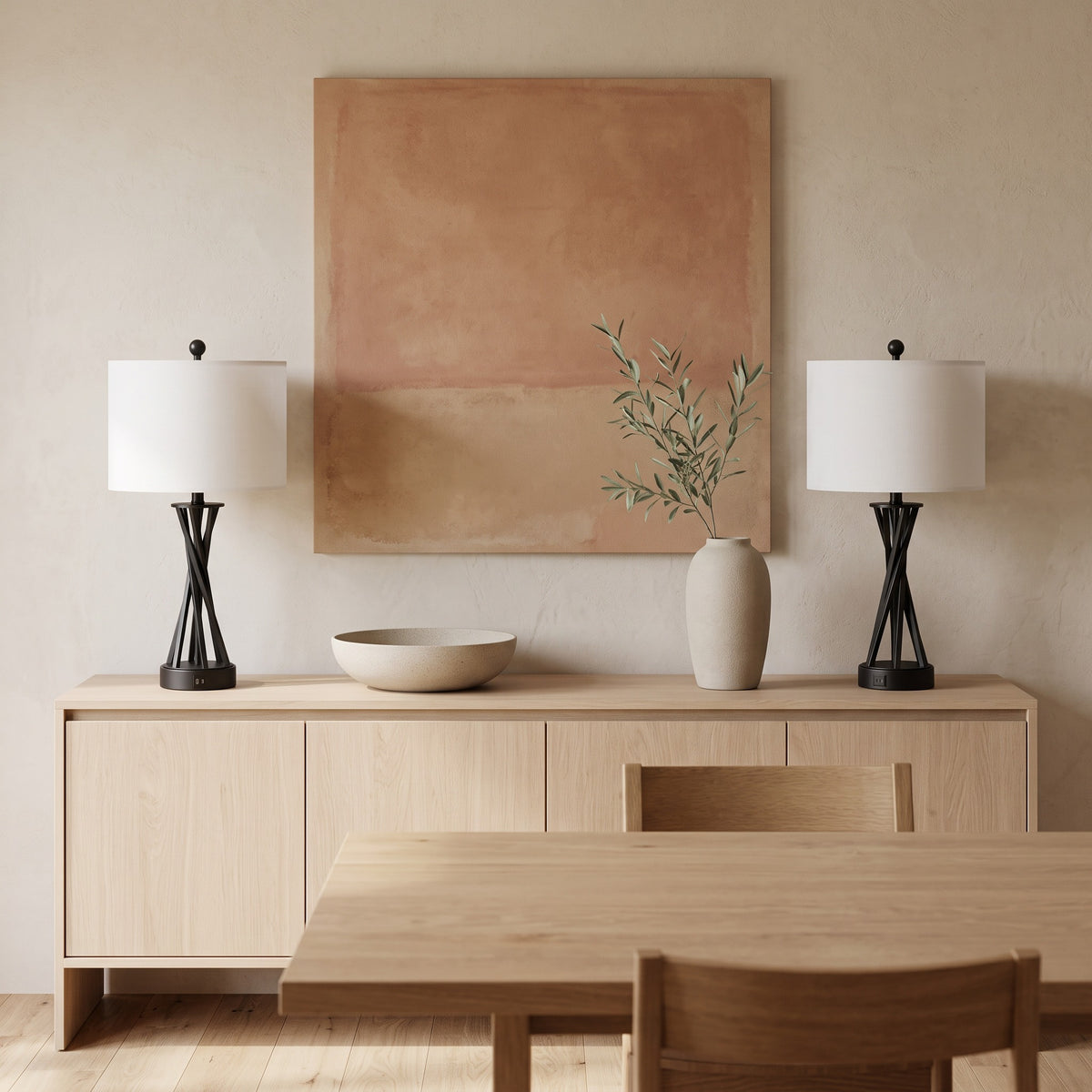 Pair of black metal table lamps with white linen-look drum shades on a light oak sideboard