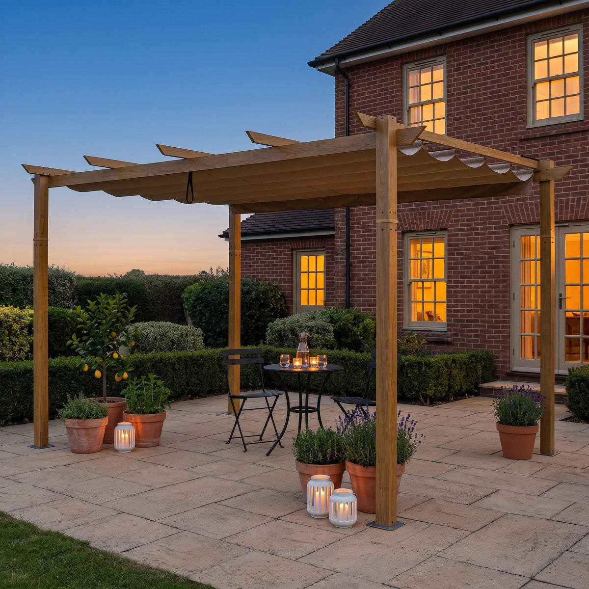 Yellow brown aluminum pergola with retractable tan canopy over a bistro table on a stone patio at dusk