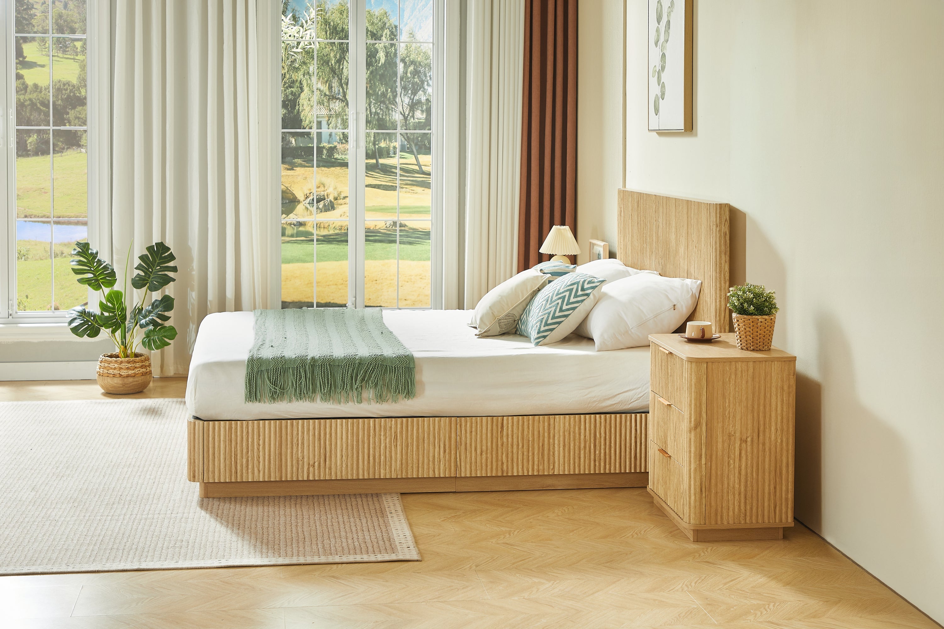 Side view of light oak fluted queen bed by a sunlit window with green throw and nightstand #Color_Oak