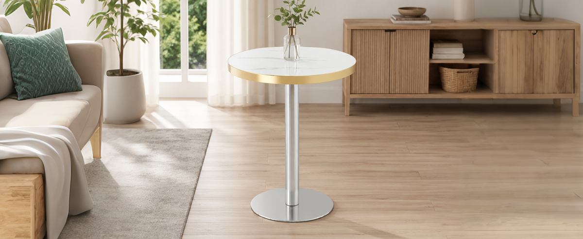 White faux marble gold-trim bistro table with chrome base in a bright living room beside a sideboard