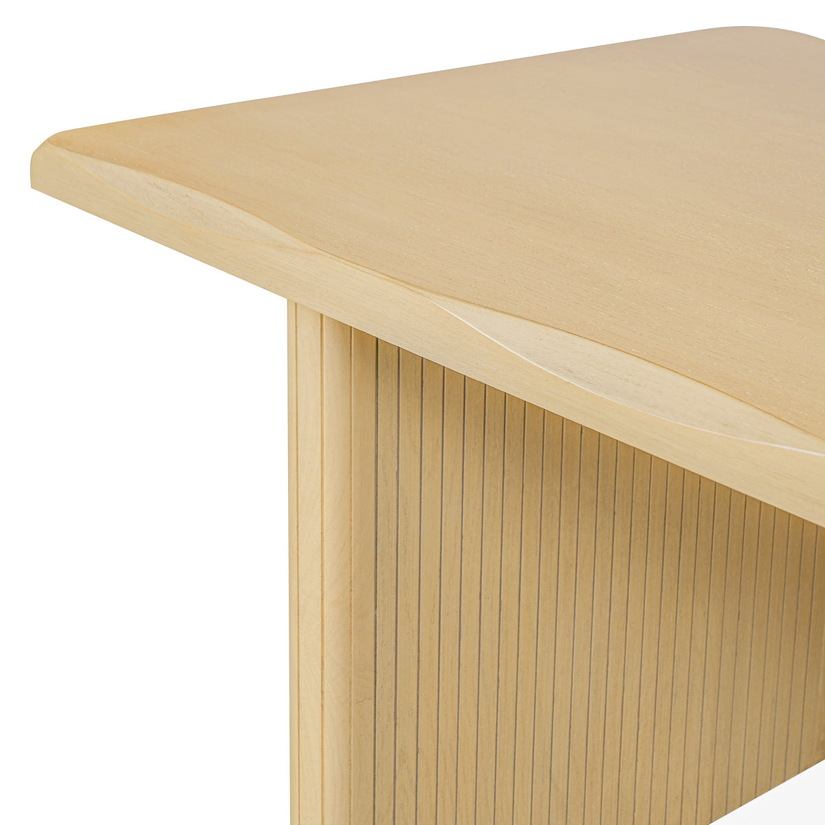 Close-up of the natural oak table corner showing scalloped edge and fluted leg