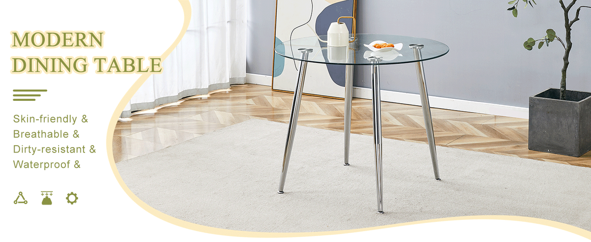 Round glass dining table with silver legs styled in a room beside a potted plant