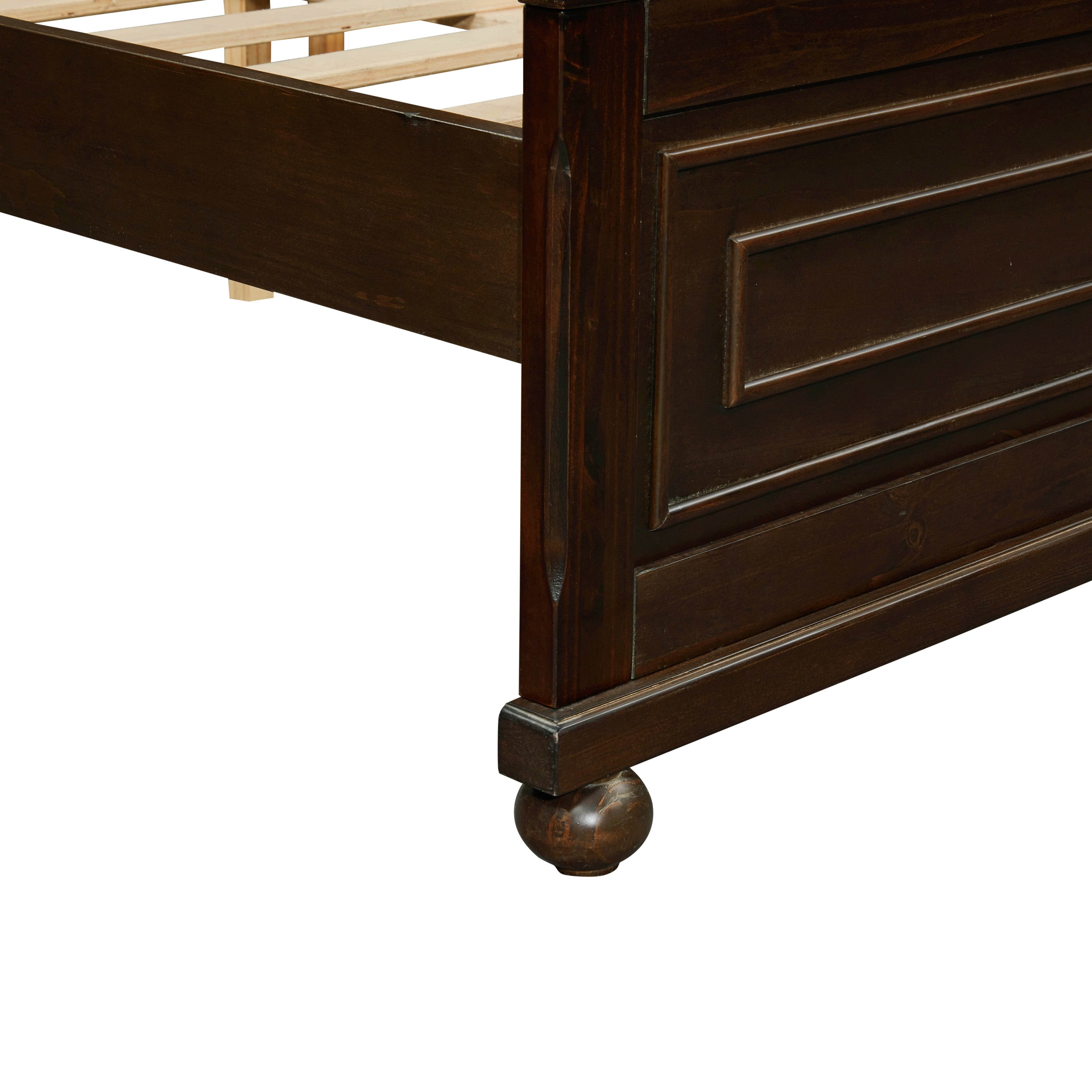 Close-up of the foot post, footboard molding and bun foot of the rich brown queen bed