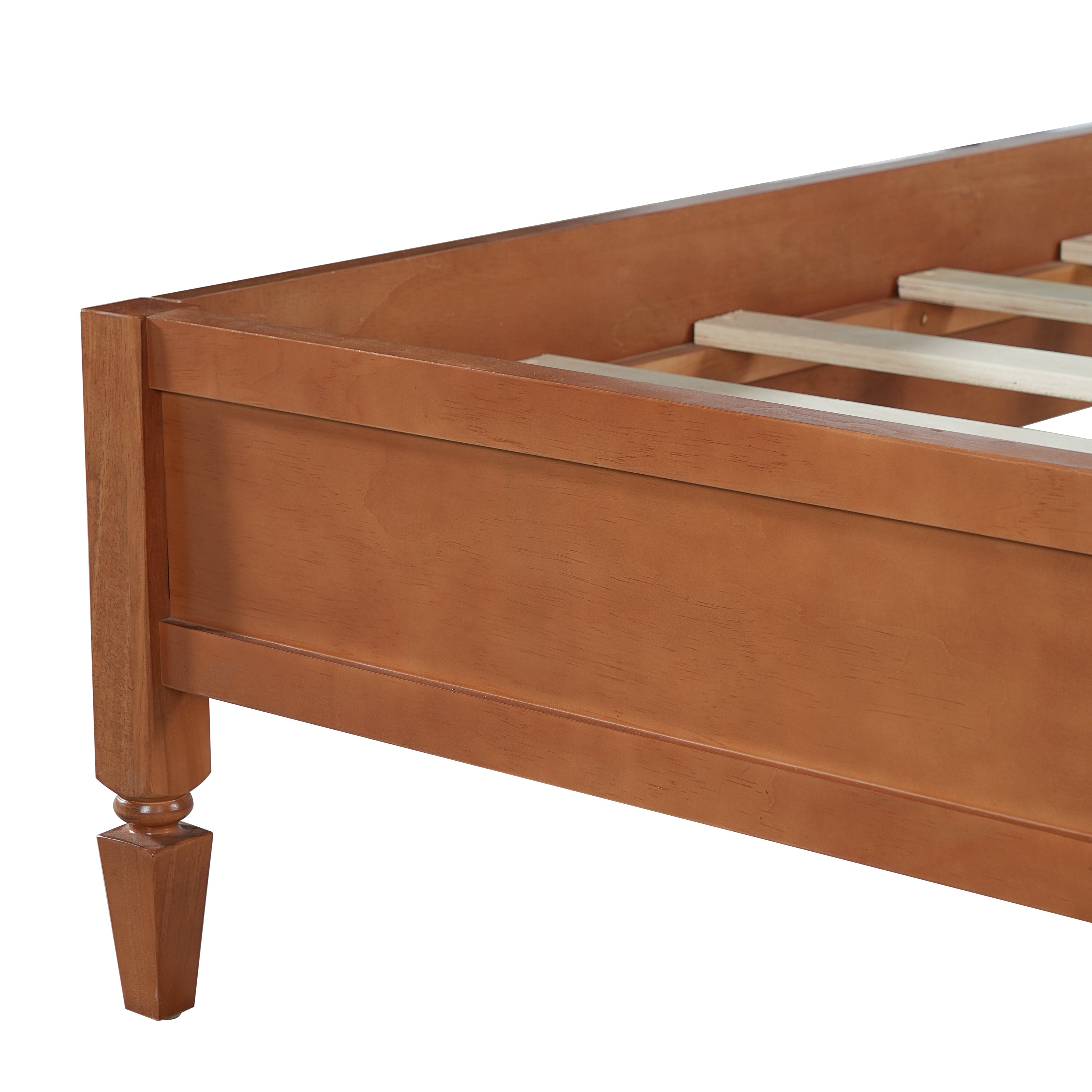 Close-up of a solid wood turned tapered leg on the brown queen platform bed