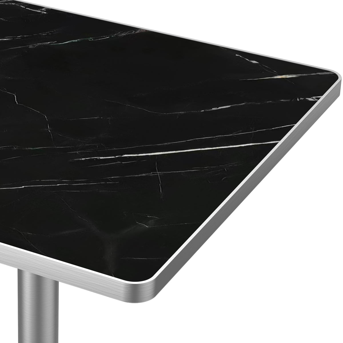 Close-up of black veined sintered stone tabletop corner and brushed silver edge trim